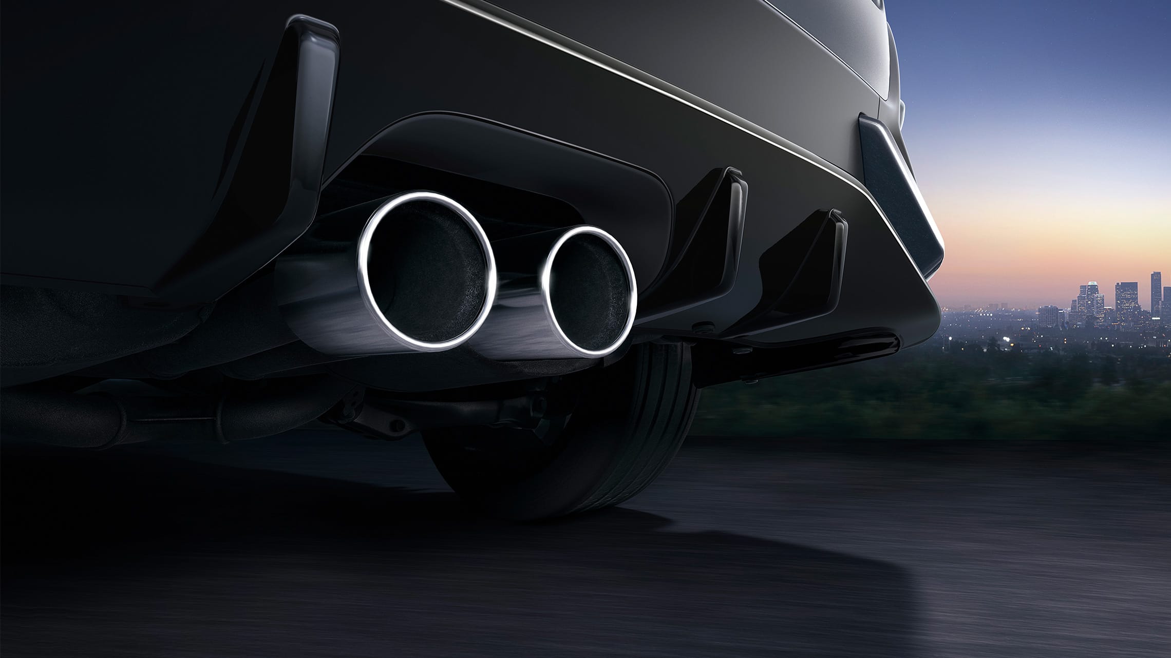 Center-mounted dual-outlet exhaust detail on the 2021 Honda Civic Sport Touring Hatchback in Sonic Gray Pearl.